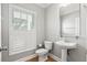 Charming powder room with pedestal sink, window with shutters, and a hardwood floor at 3095 S Shore Dr, Charleston, SC 29407