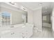 Bright bathroom featuring a double vanity, tiled floors, toilet, and separate shower with tub at 3095 S Shore Dr, Charleston, SC 29407