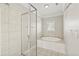 A bathroom features a glass shower, soaking tub, tiled walls, and trim detail at 3095 S Shore Dr, Charleston, SC 29407