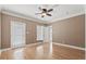 Bedroom featuring hardwood floors, tan walls, ceiling fan, and access to a balcony at 3095 S Shore Dr, Charleston, SC 29407