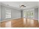 Spacious bedroom with light hardwood floors, large windows, ceiling fan and access to an outdoor balcony at 3095 S Shore Dr, Charleston, SC 29407