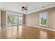 Large bedroom featuring a ceiling fan, hardwood floors, balcony doors and lots of natural light at 3095 S Shore Dr, Charleston, SC 29407