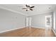 A bedroom with hardwood floors, neutral walls, crown molding, and access to a bathroom at 3095 S Shore Dr, Charleston, SC 29407