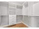 Spacious walk-in closet featuring custom shelving, drawers, and hardwood floor at 3095 S Shore Dr, Charleston, SC 29407