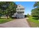 Attractive multi-story home with a well-maintained lawn and inviting double porches at 3095 S Shore Dr, Charleston, SC 29407