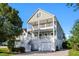 Two-story coastal style home with dual balconies and white railings at 3095 S Shore Dr, Charleston, SC 29407