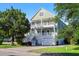 Two-story coastal style home with dual balconies and white railings at 3095 S Shore Dr, Charleston, SC 29407