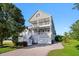 Inviting two-story home featuring double porches and a well-manicured lawn at 3095 S Shore Dr, Charleston, SC 29407