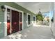 Inviting front porch with wooden door and lantern-style lighting at 3095 S Shore Dr, Charleston, SC 29407