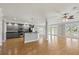 Open kitchen and living room featuring gray cabinets, breakfast bar, stainless appliances, and balcony access at 3095 S Shore Dr, Charleston, SC 29407