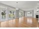 Bright living room featuring hardwood floors, fireplace, elegant lighting, and balcony access at 3095 S Shore Dr, Charleston, SC 29407