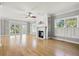 Spacious living room featuring a fireplace, built-in shelving, balcony access, and a large window at 3095 S Shore Dr, Charleston, SC 29407