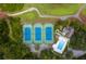 Aerial view showcases tennis courts, a pool, and lush landscaping, highlighting recreational amenities and serene surroundings at 3221 Johnstowne St, Johns Island, SC 29455