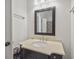 Bathroom features a vanity with a cream-colored countertop and decorative mirror with modern faucet and hardware at 3221 Johnstowne St, Johns Island, SC 29455