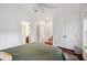 A stylish bedroom with hardwood floors, featuring double doors leading to a closet and a glimpse into the bathroom at 3221 Johnstowne St, Johns Island, SC 29455
