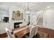 Elegant dining room with a fireplace, hardwood floors, and neutral decor near staircase at 3221 Johnstowne St, Johns Island, SC 29455