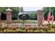 Welcoming entrance to Kiawah River Estates with brick columns, a decorative gate, and colorful flower beds at 3221 Johnstowne St, Johns Island, SC 29455