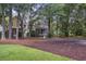 Two story home with a screened porch, white railing, and large trees at 3221 Johnstowne St, Johns Island, SC 29455