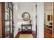 Bright foyer features a round mirror, hardwood floors, and an inviting view into the home at 3221 Johnstowne St, Johns Island, SC 29455