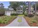 Charming two-story home with a detached garage, landscaped yard, and inviting curb appeal at 3221 Johnstowne St, Johns Island, SC 29455