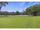 Beautiful, expansive golf course with manicured greens, sand traps, and mature trees under a blue sky at 3221 Johnstowne St, Johns Island, SC 29455