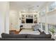 Cozy living room with built-in shelving, ceiling fan, and plenty of natural light at 3221 Johnstowne St, Johns Island, SC 29455