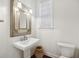 Stylish powder room with ornate mirror and classic pedestal sink at 3221 Johnstowne St, Johns Island, SC 29455