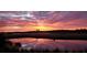 Spectacular sunset view over the golf course pond, reflecting vibrant colors across the sky at 3221 Johnstowne St, Johns Island, SC 29455