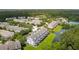 Aerial view of townhome community with pond, manicured lawns, and mature trees surrounding the area at 3616 Bagley Dr, Mount Pleasant, SC 29466