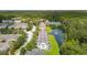 Aerial view of townhomes bordering a pond, with lush greenery and a tennis court in the community at 3616 Bagley Dr, Mount Pleasant, SC 29466