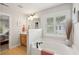 Open bathroom design connects a soaking tub and window to the double vanity, with view to bedroom at 3616 Bagley Dr, Mount Pleasant, SC 29466