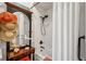 Bright bathroom with a tub, shower and decorative hats on a wall-mounted antique mirror at 3616 Bagley Dr, Mount Pleasant, SC 29466