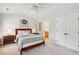 Spacious bedroom with ceiling fan, decorative window, and view into the bathroom with double door closet at 3616 Bagley Dr, Mount Pleasant, SC 29466
