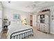 Charming bedroom featuring a wrought iron bed frame, white bedding, and vintage hutch at 3616 Bagley Dr, Mount Pleasant, SC 29466