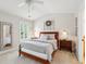 Well-lit bedroom features a ceiling fan, light-toned walls, window shutters and elegant wood bed frame at 3616 Bagley Dr, Mount Pleasant, SC 29466