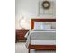 Comfortable bedroom features a wood-framed bed, decorative pillow, and unique lamp on the matching wood nightstand at 3616 Bagley Dr, Mount Pleasant, SC 29466