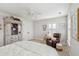 Bright bedroom featuring a ceiling fan, hutch, and leather chair with a white bedspread at 3616 Bagley Dr, Mount Pleasant, SC 29466