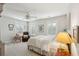 Sun-filled primary bedroom offers shutters on the windows, a ceiling fan, a plush armchair, and bedside lighting at 3616 Bagley Dr, Mount Pleasant, SC 29466