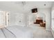 Large bedroom features a ceiling fan and arched doorway, with access to the bathroom and walk in closet at 3616 Bagley Dr, Mount Pleasant, SC 29466