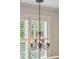Chandelier with white shutters for natural light in the background at 3616 Bagley Dr, Mount Pleasant, SC 29466