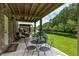 Charming covered patio with seating, perfect for enjoying the tranquil view of the pond and landscaped backyard at 3616 Bagley Dr, Mount Pleasant, SC 29466
