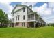 Exterior showing the home's back decks, patios, brick foundation, and lush green lawn at 3616 Bagley Dr, Mount Pleasant, SC 29466