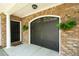 Close up of the garage featuring brick accents and a hanging fern detail at 3616 Bagley Dr, Mount Pleasant, SC 29466