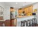 A well-lit kitchen features wood floors, tan cabinets, stainless steel appliances, and an island with barstool seating at 3616 Bagley Dr, Mount Pleasant, SC 29466