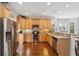 Bright kitchen with wood floors, tan cabinets, stainless steel appliances, and lots of countertop space at 3616 Bagley Dr, Mount Pleasant, SC 29466