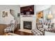 Cozy living room with fireplace, plaid armchairs, and a view into the kitchen at 3616 Bagley Dr, Mount Pleasant, SC 29466