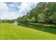 Picturesque pond view with a fountain surrounded by lush greenery and mature trees at 3616 Bagley Dr, Mount Pleasant, SC 29466