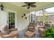 A screened-in porch with an outdoor seating arrangement with wicker chairs and table at 3616 Bagley Dr, Mount Pleasant, SC 29466