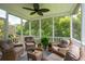 A relaxing screened-in patio includes four chairs and a ceiling fan at 3616 Bagley Dr, Mount Pleasant, SC 29466