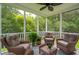 Screened patio with four chairs, a table, ceiling fan, and view of the backyard woods at 3616 Bagley Dr, Mount Pleasant, SC 29466